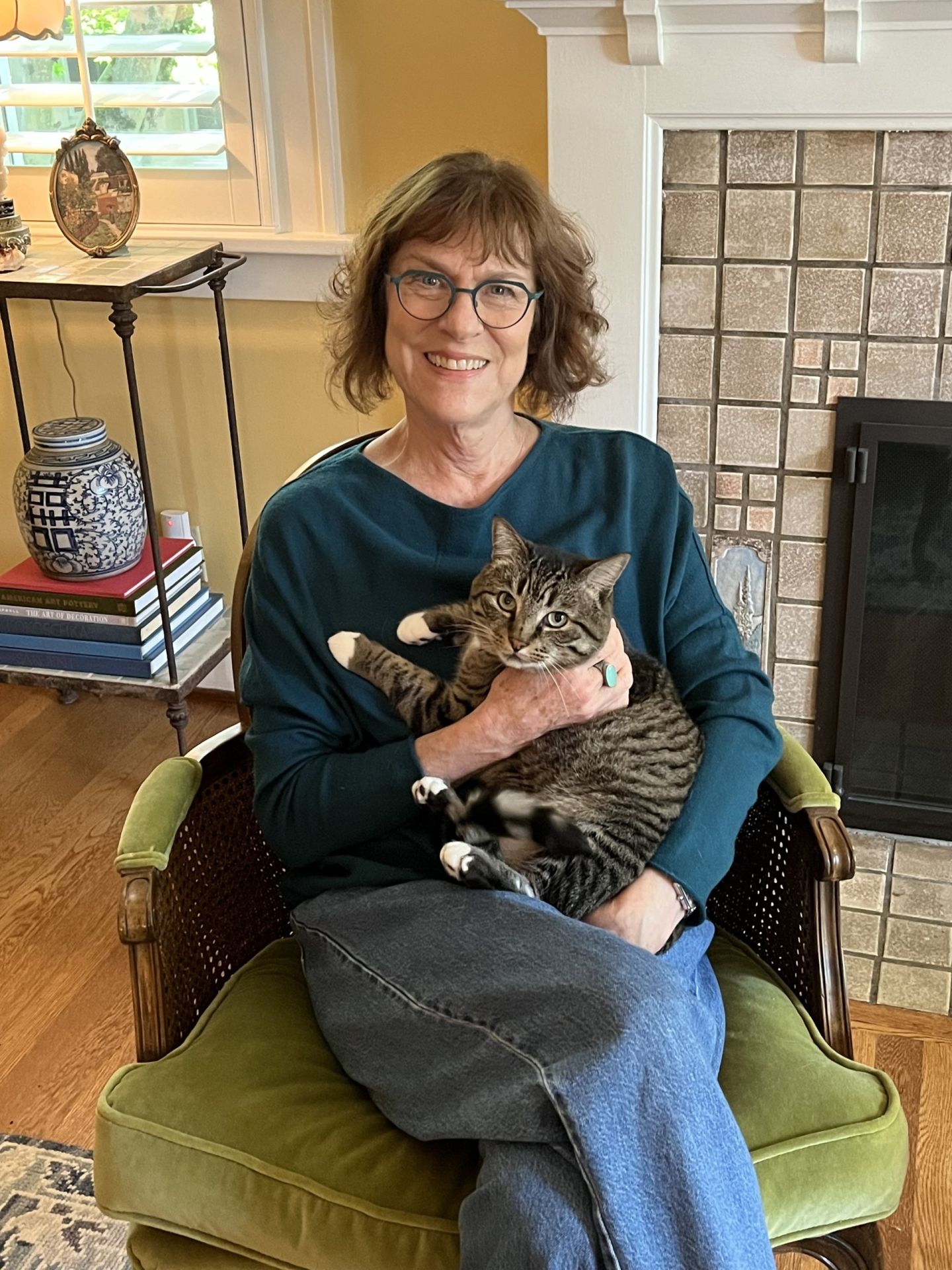 Nancy and her cat, Meatball, sitting in a chair together